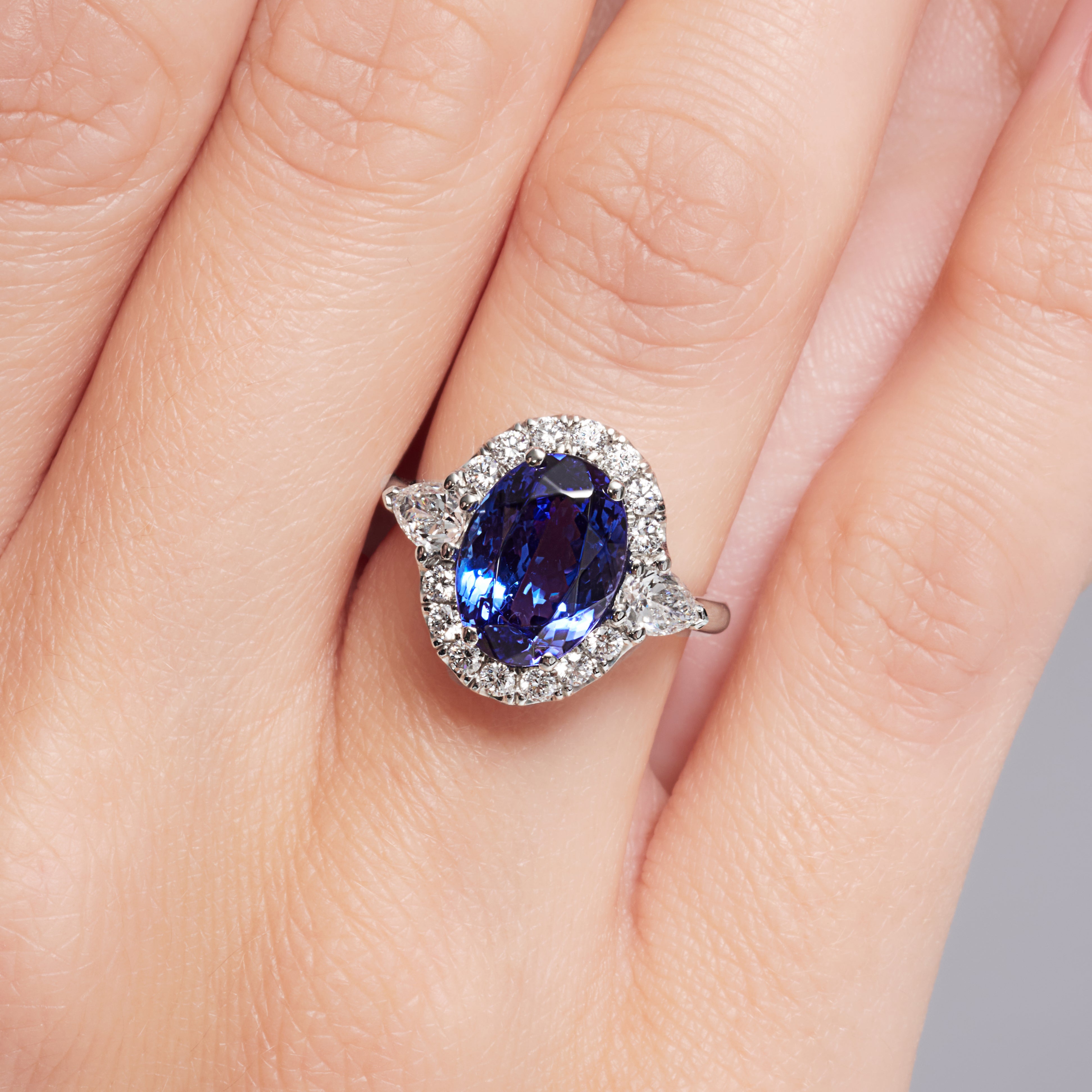 Tanzanite And Pear Shape Diamond Halo Ring In Platinum.