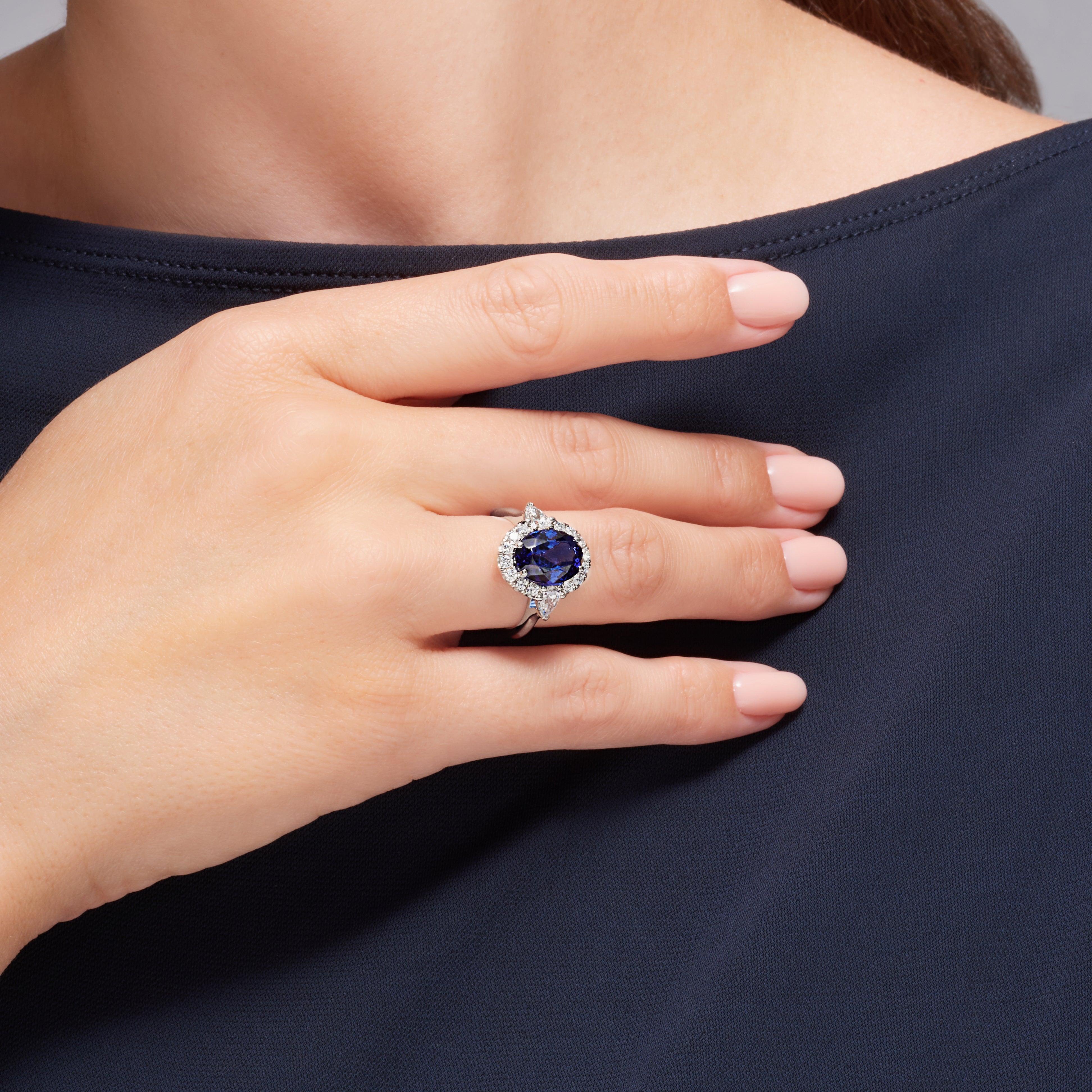 Tanzanite And Pear Shape Diamond Halo Ring In Platinum.