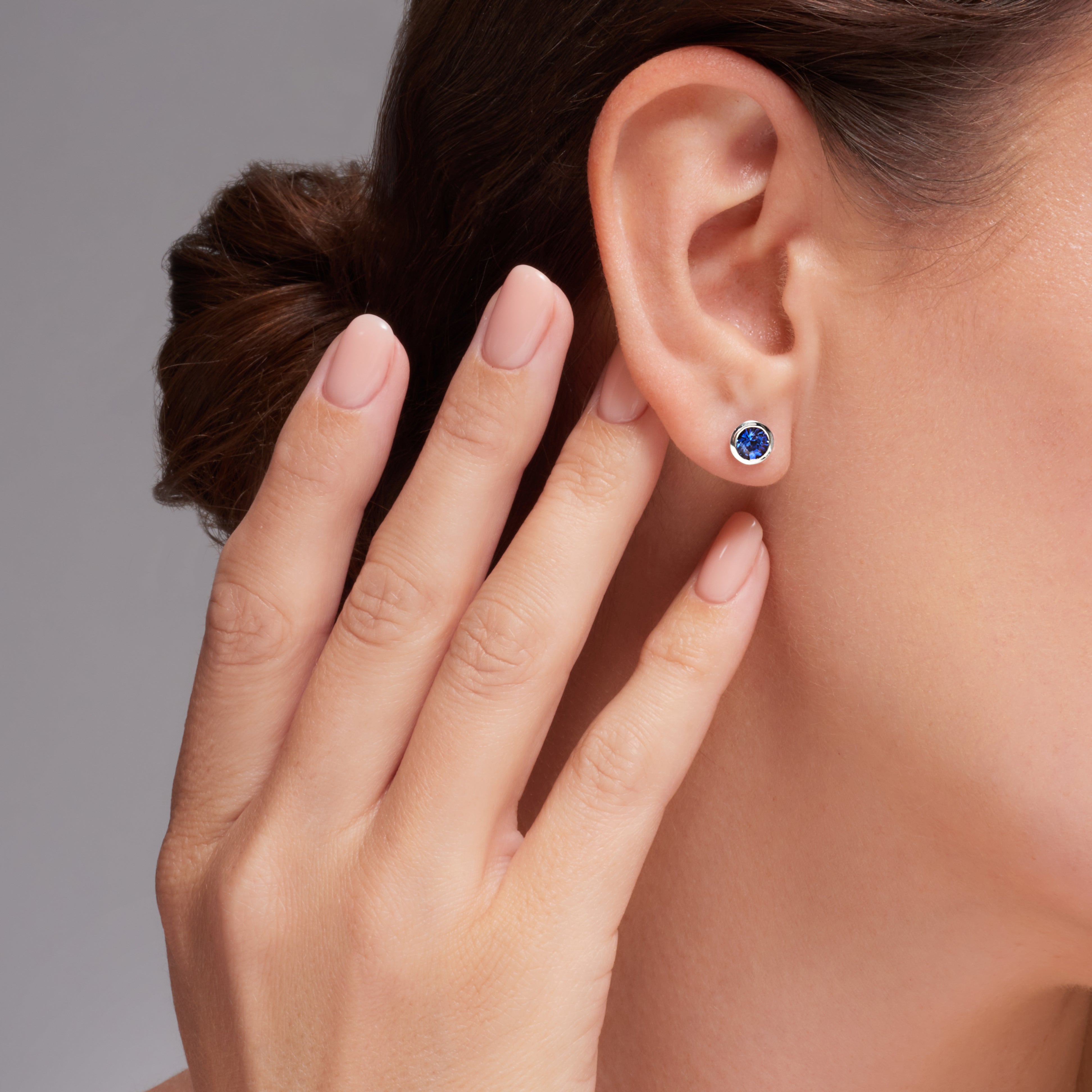 Blue Sapphire Bezel Set Earrings In 18 Karat White Gold