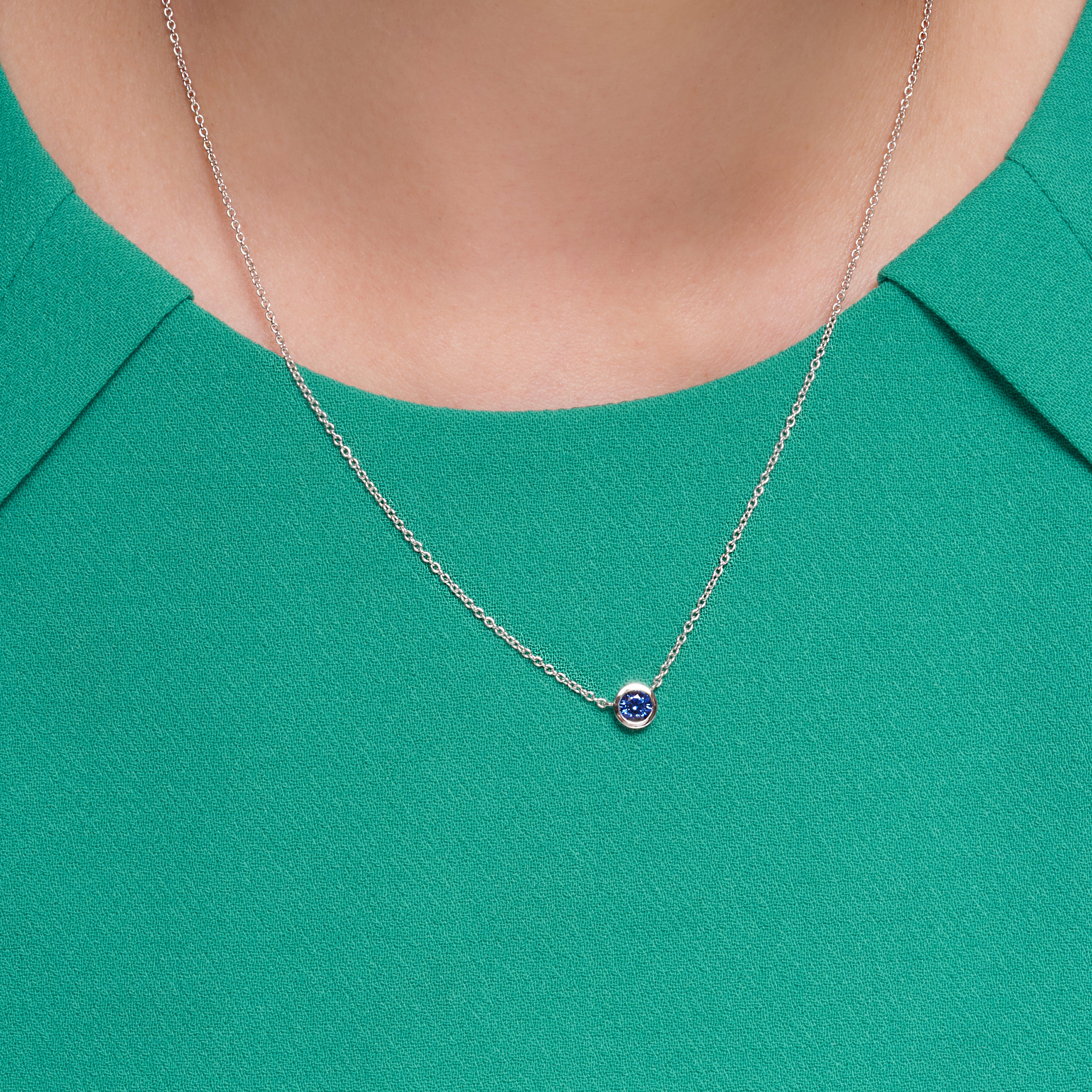 Blue Sapphire Bezel Set Pendant In 18 Karat White Gold