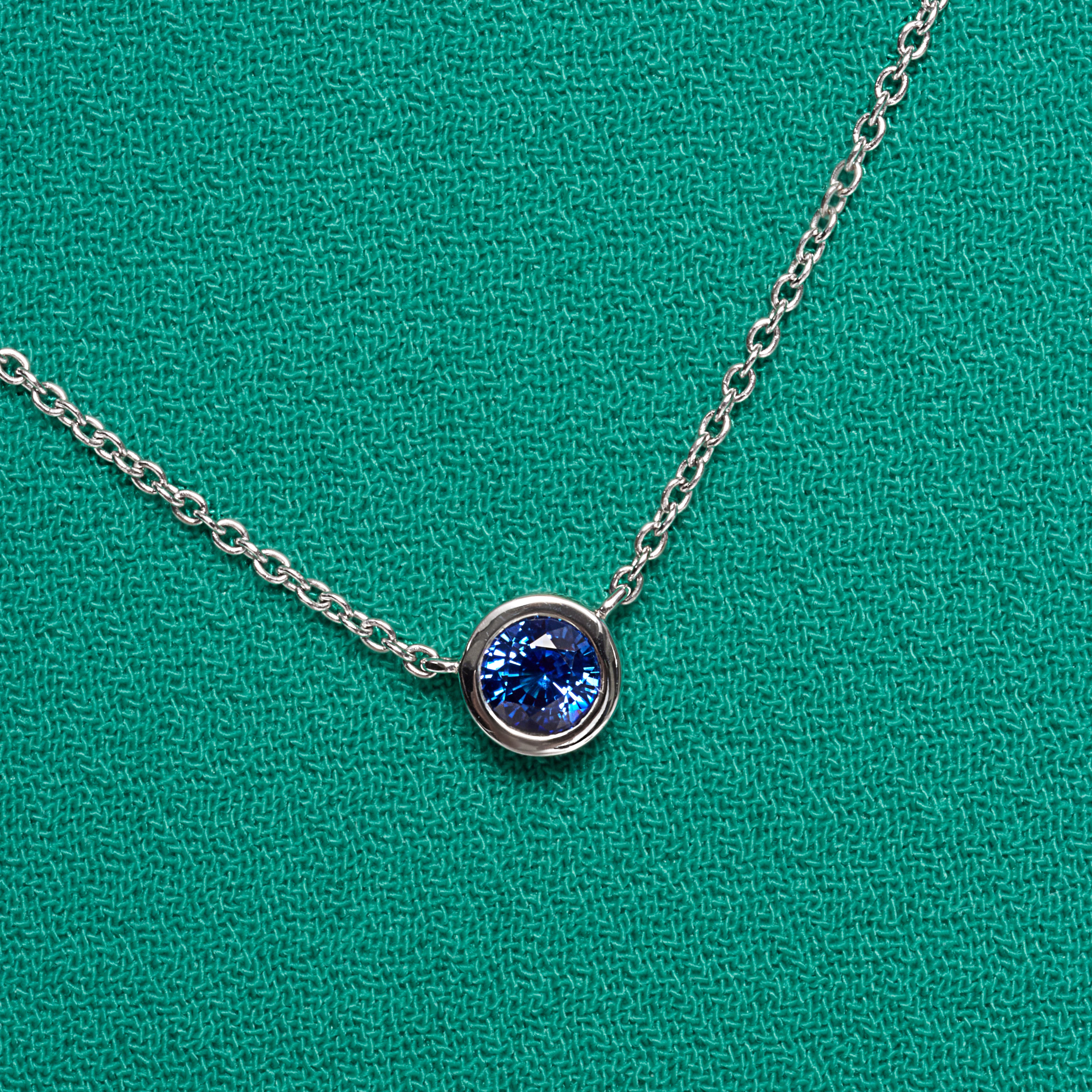 Blue Sapphire Bezel Set Pendant In 18 Karat White Gold