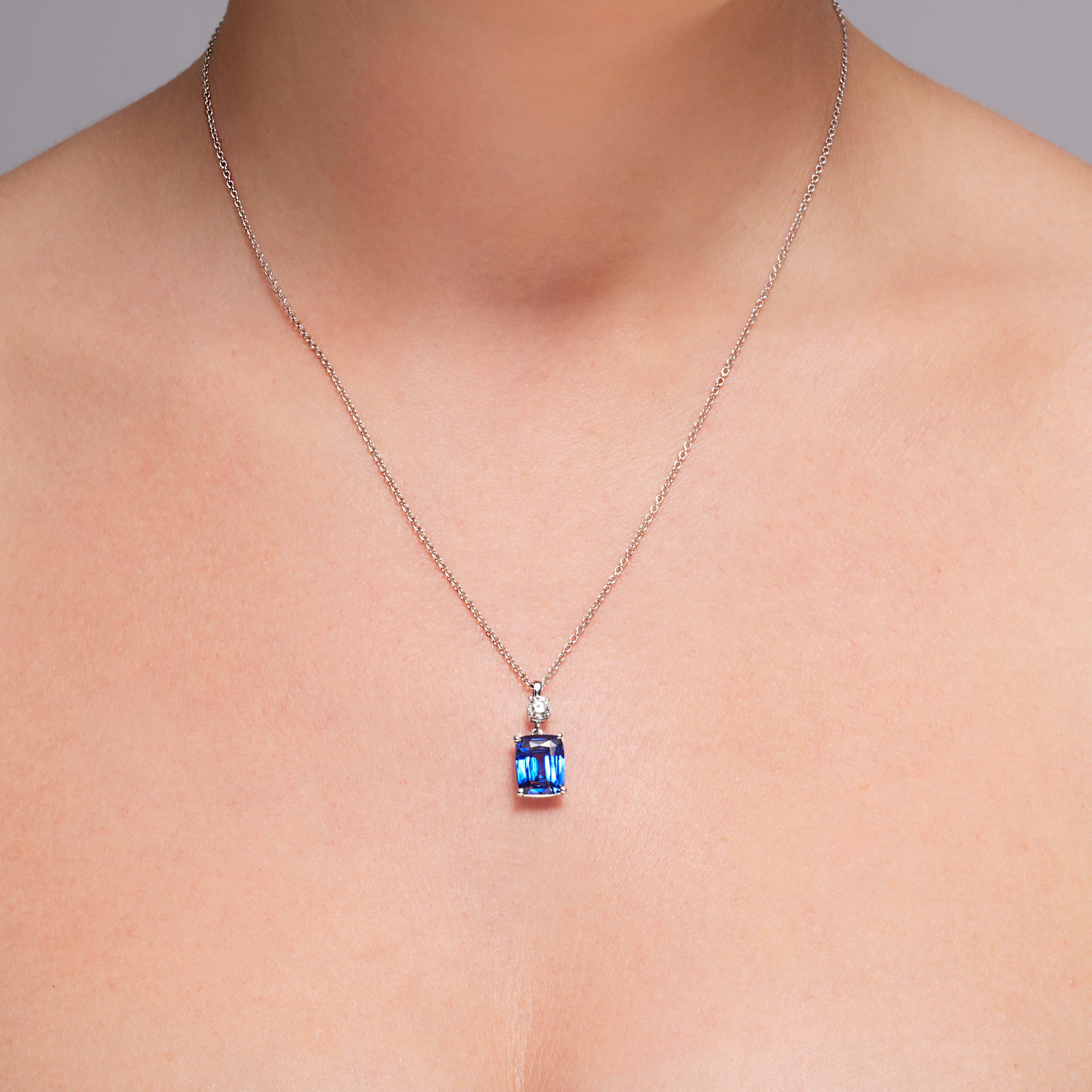 Blue Sapphire And Diamond Dangling Pendant In 18 Karat White Gold