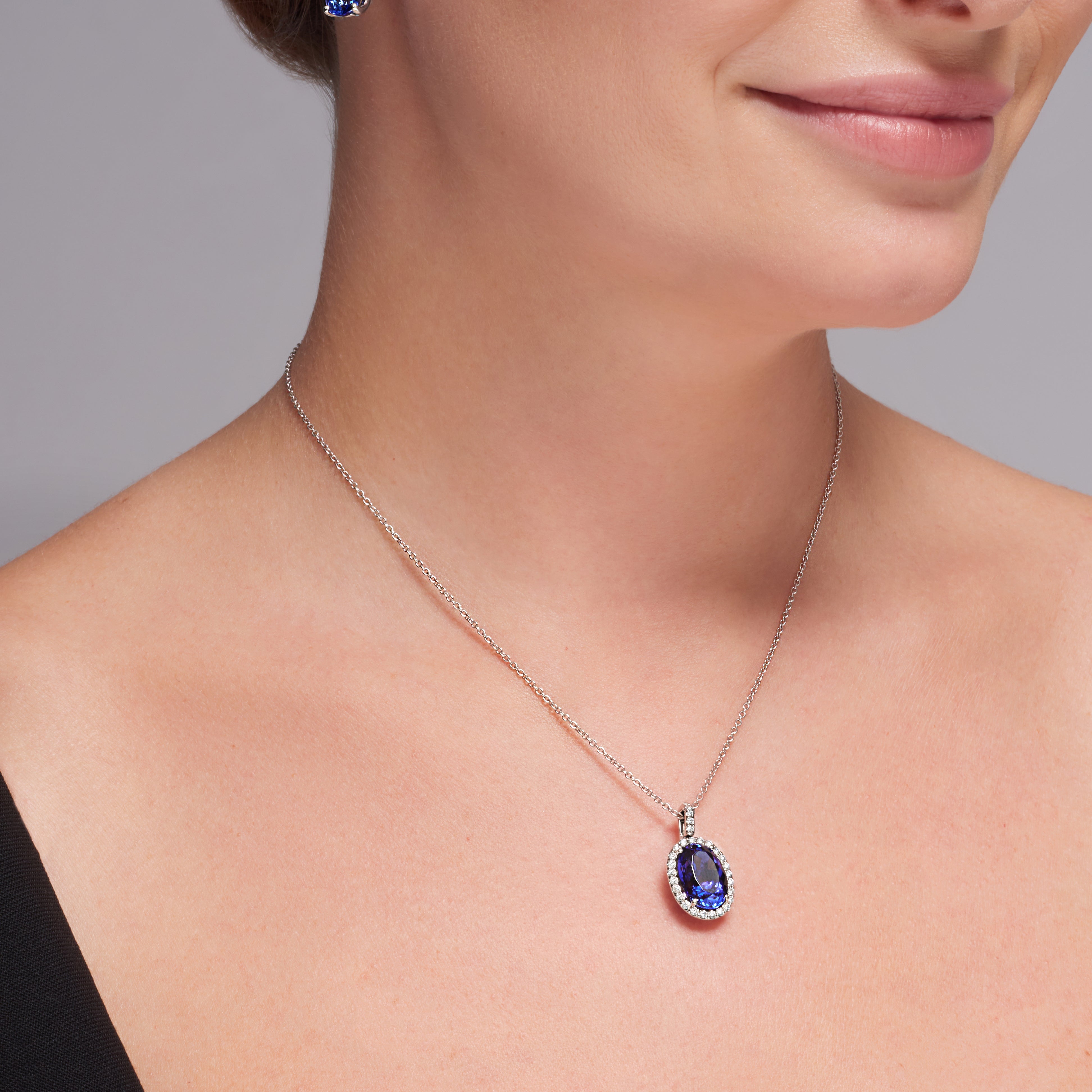 Oval Shape Tanzanite Diamond Halo Pendant In 18 Karat White Gold
