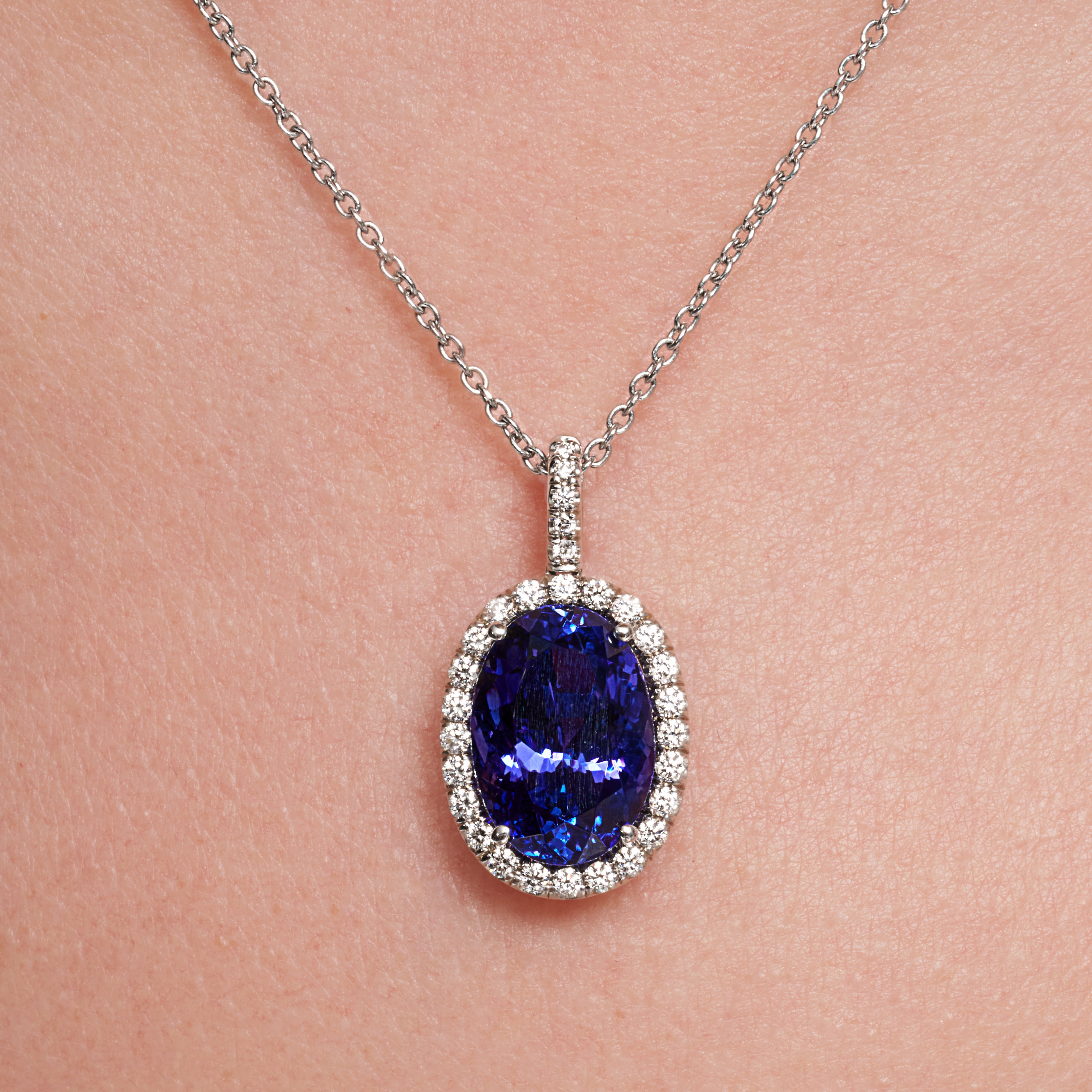 Oval Shape Tanzanite Diamond Halo Pendant In 18 Karat White Gold