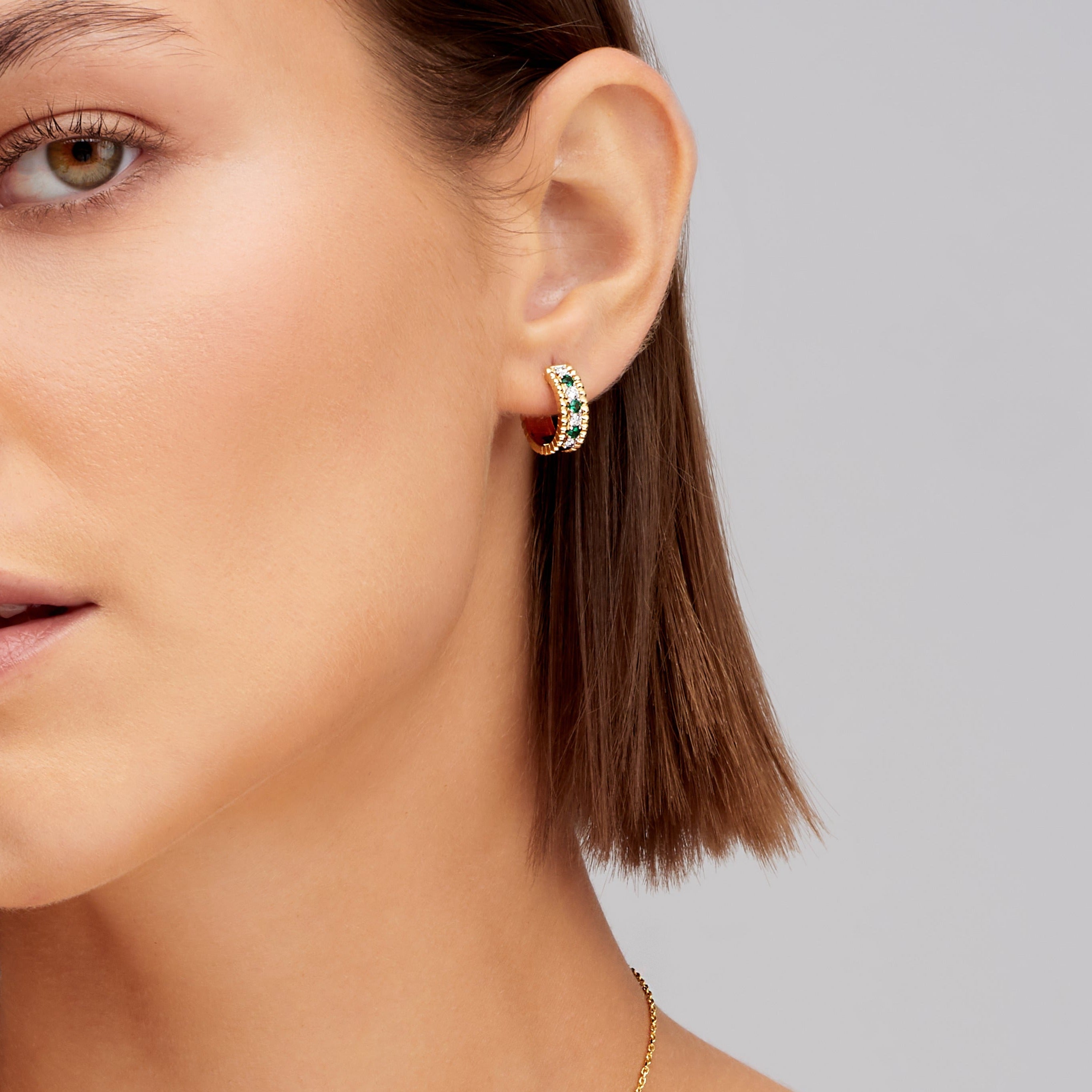 Alternating Diamond and Emerald Huggie Earrings in 18K Yellow Gold