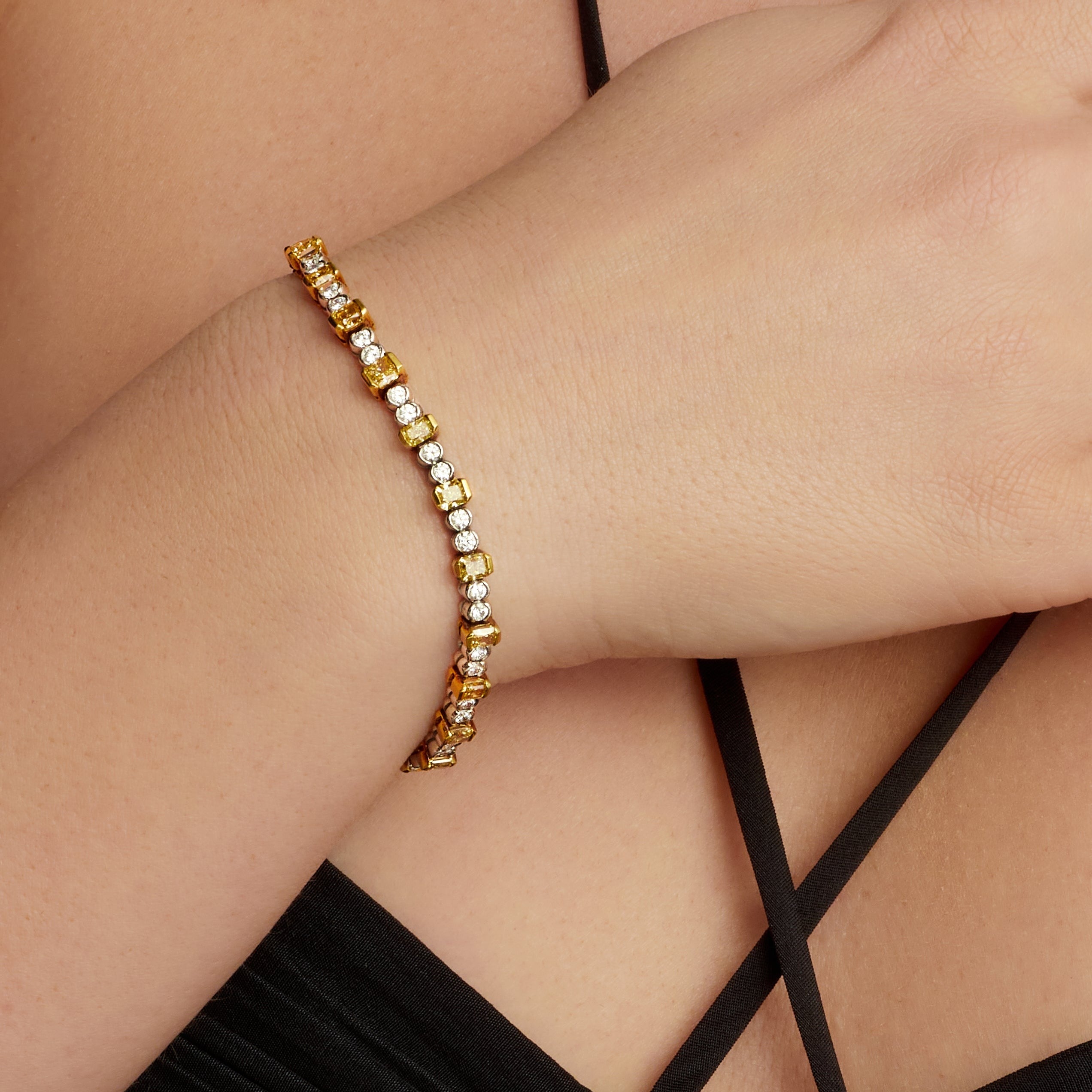 Alternating Emerald Cut Fancy Yellow Diamond and Round Cut Diamond Tennis Bracelet in 18 Karat Yellow Gold and Platinum