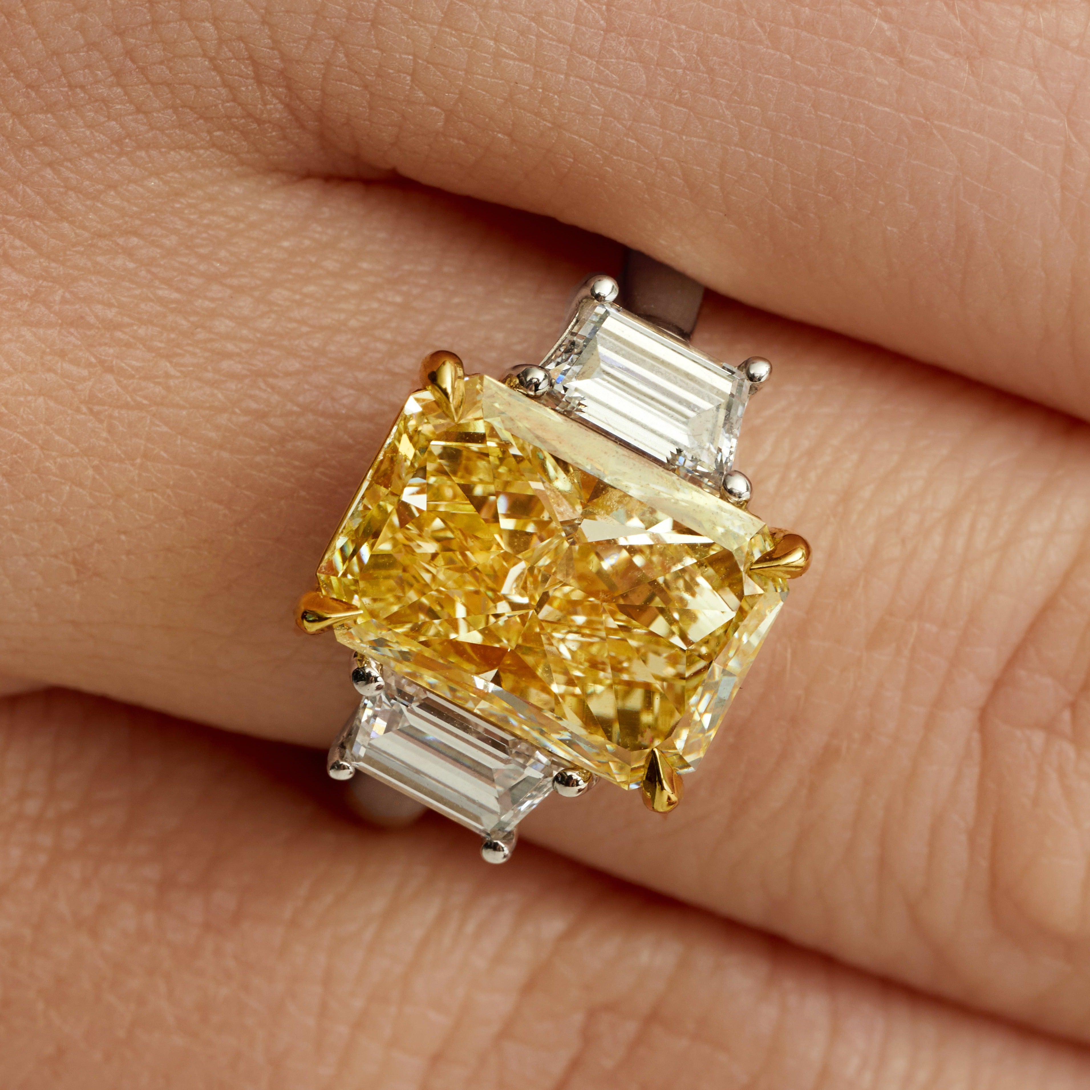 Radiant Cut Fancy Yellow Diamond and Trapezoid Diamond Side Stones Three Stone Ring in 18 Karat Yellow Gold and Platinum