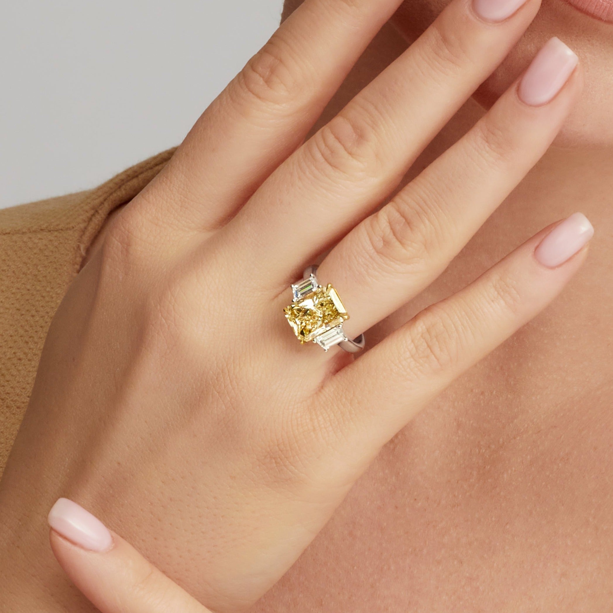 Radiant Cut Fancy Yellow Diamond and Trapezoid Diamond Side Stones Three Stone Ring in 18 Karat Yellow Gold and Platinum