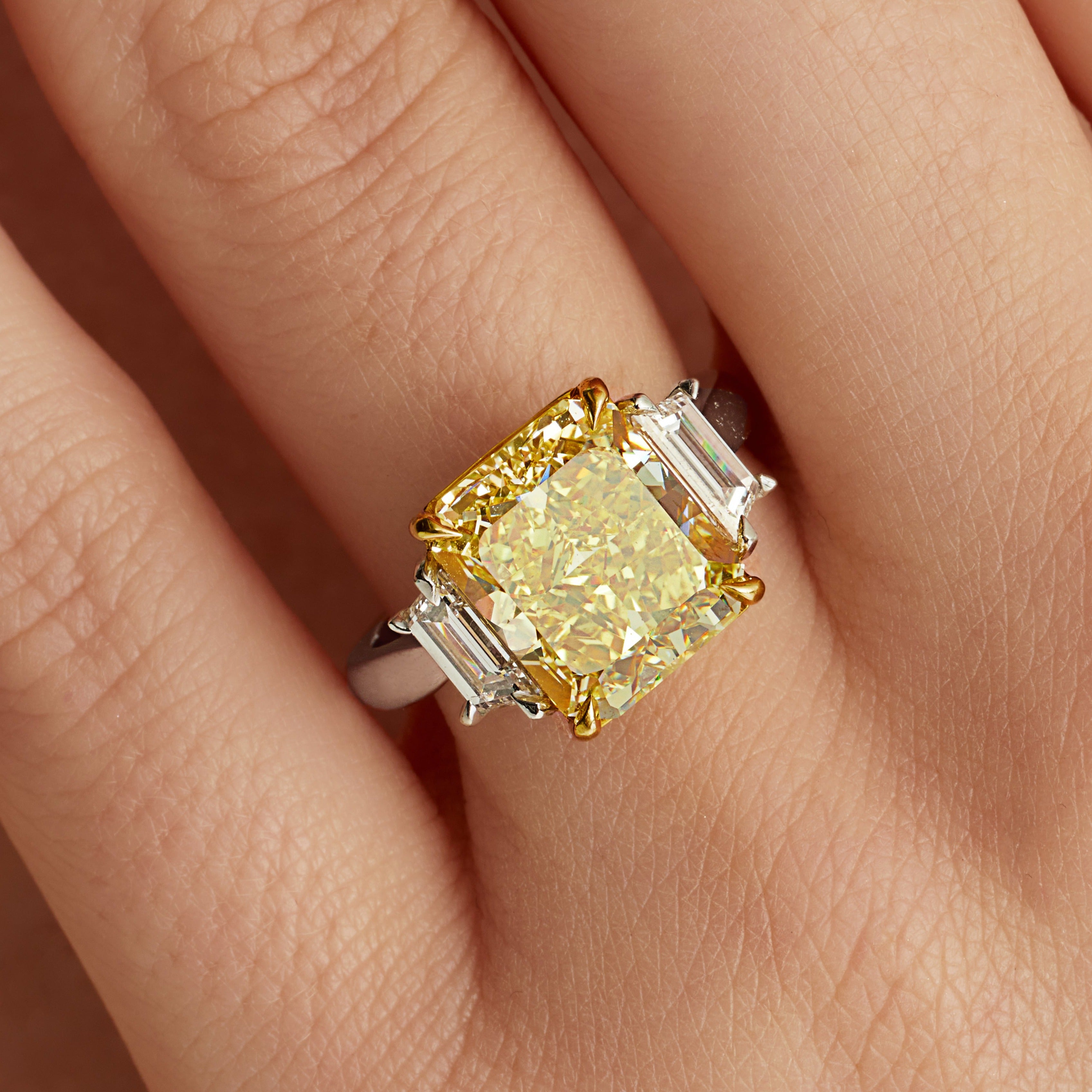 Radiant Cut Fancy Intense Yellow Diamond and Trapezoid Diamond Side Stones Ring in 18 Karat Yellow Gold and Platinum