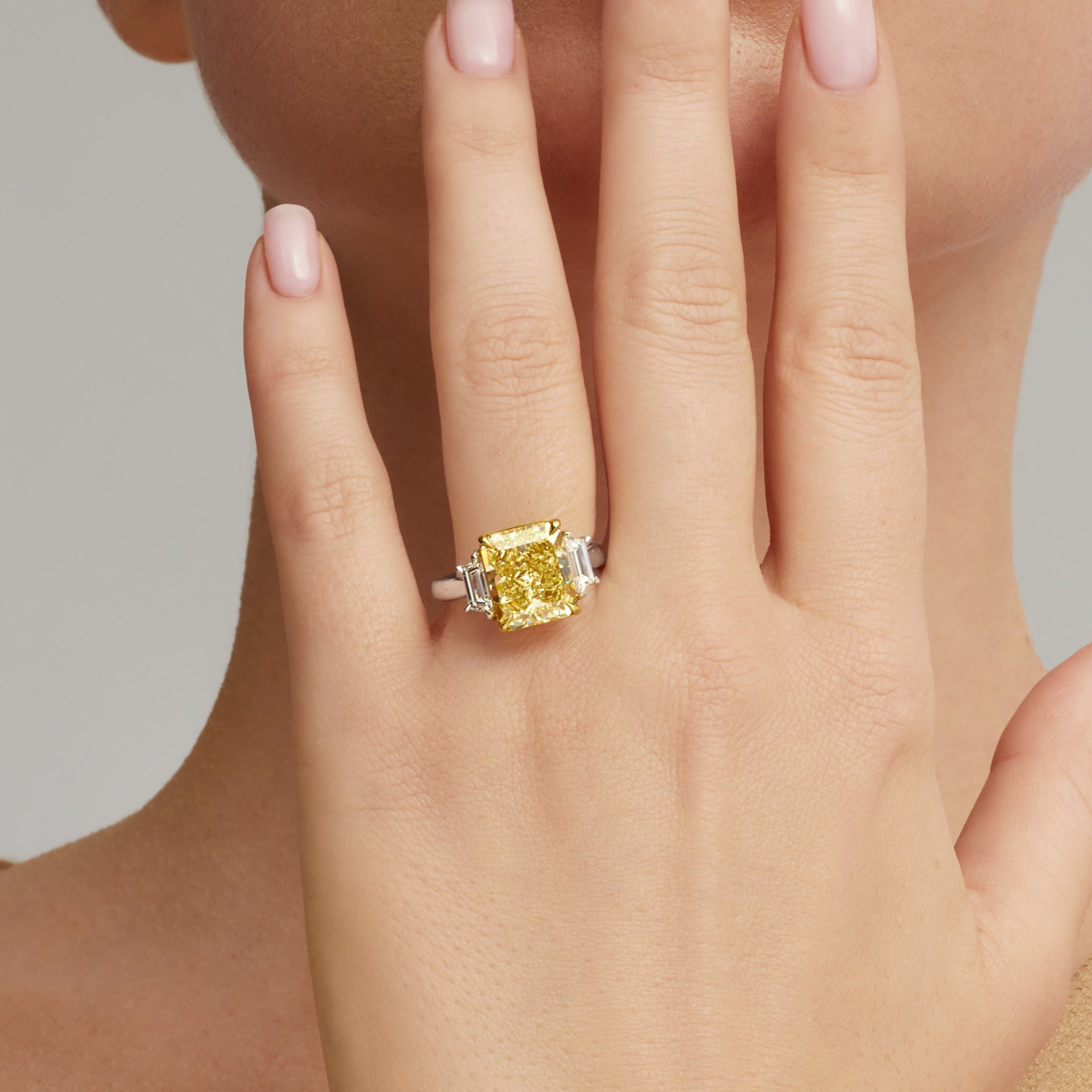 Radiant Cut Fancy Intense Yellow Diamond and Trapezoid Diamond Side Stones Ring in 18 Karat Yellow Gold and Platinum