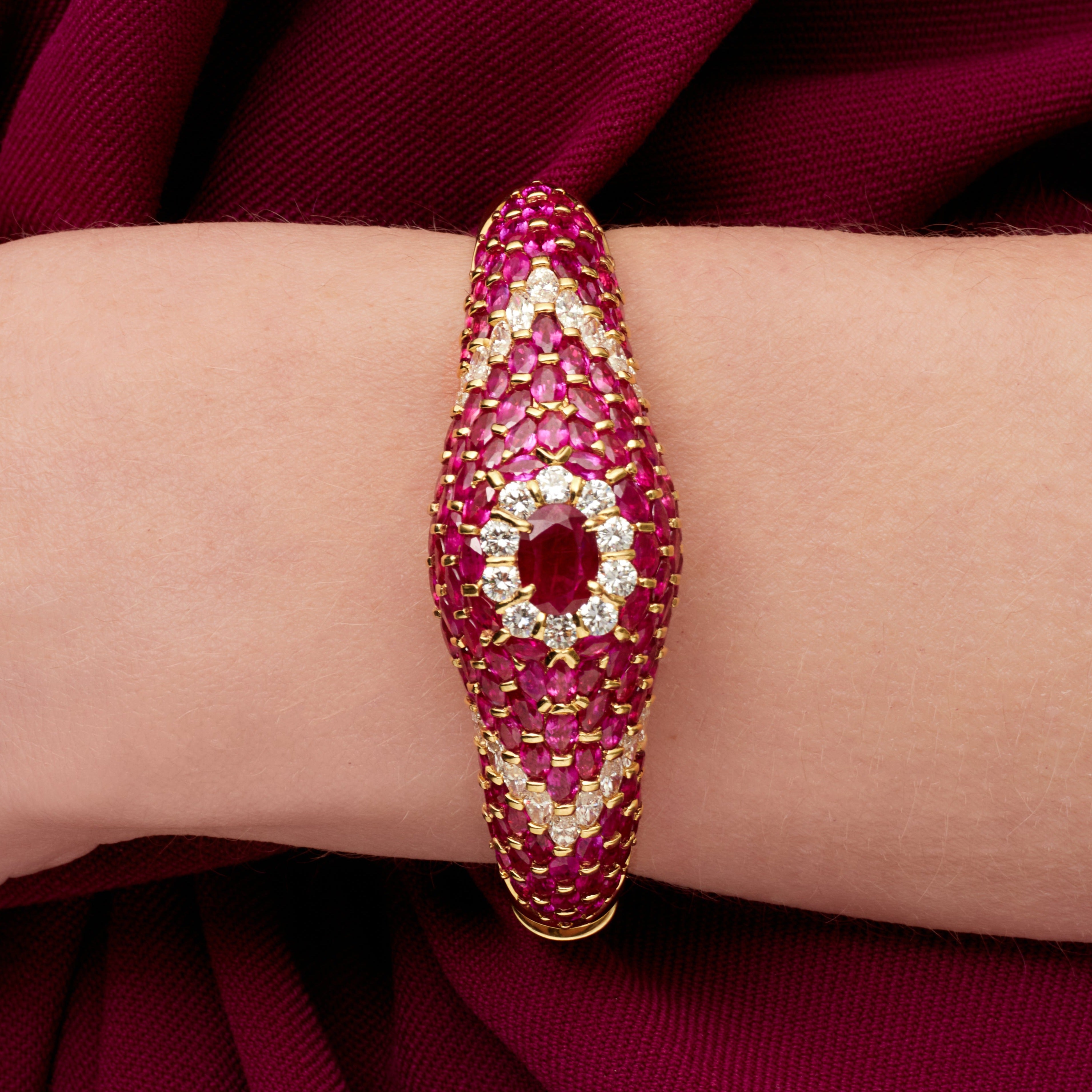 Oval Cut Ruby Cuff Bracelet with Diamond Accents in Yellow Gold