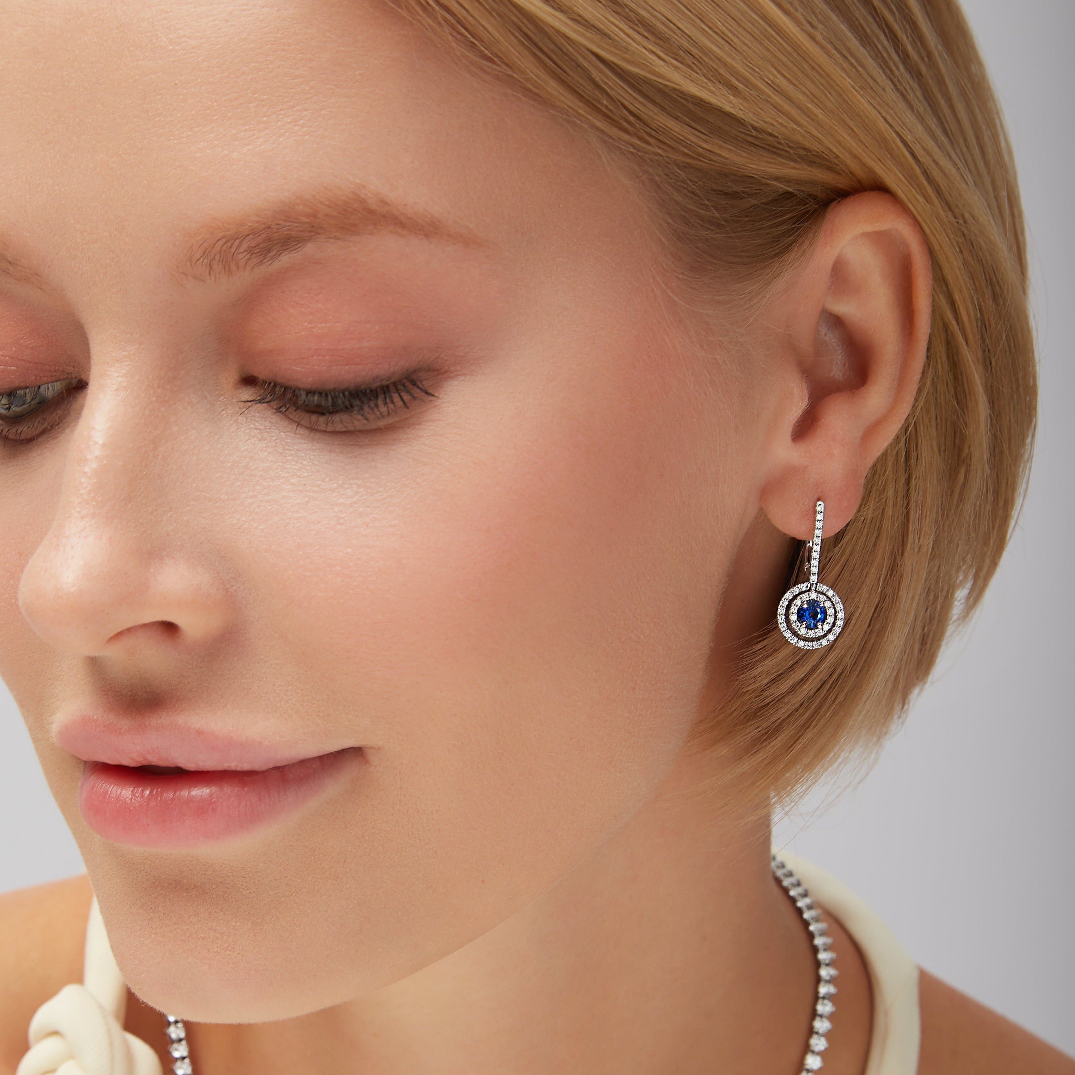 Round Brilliant Sapphire Center Stone and Diamond Leverback Earrings in 18K White Gold