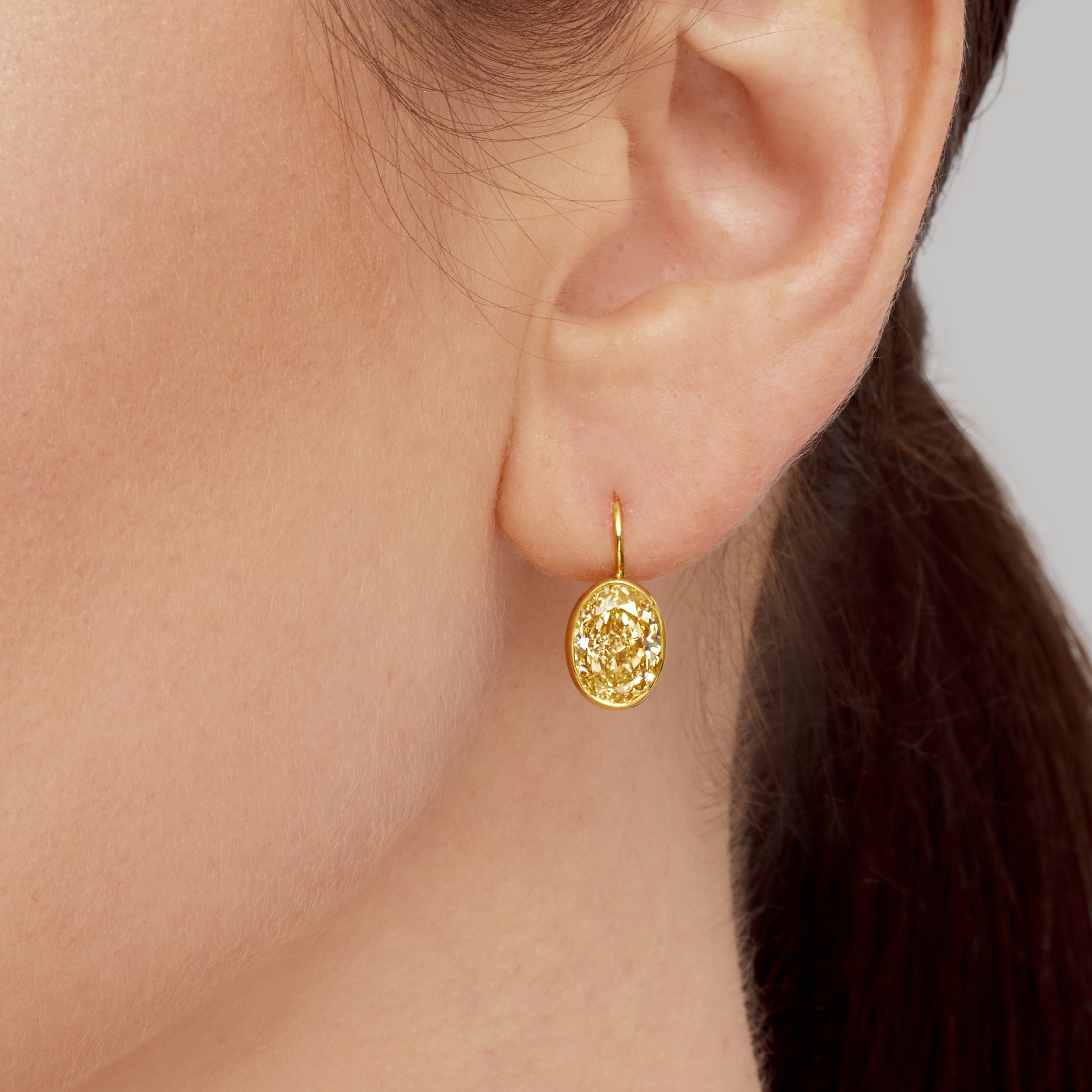 Oval Cut Bezel Set Fancy Yellow Diamond Dangle Earrings in 18 Karat Yellow Gold