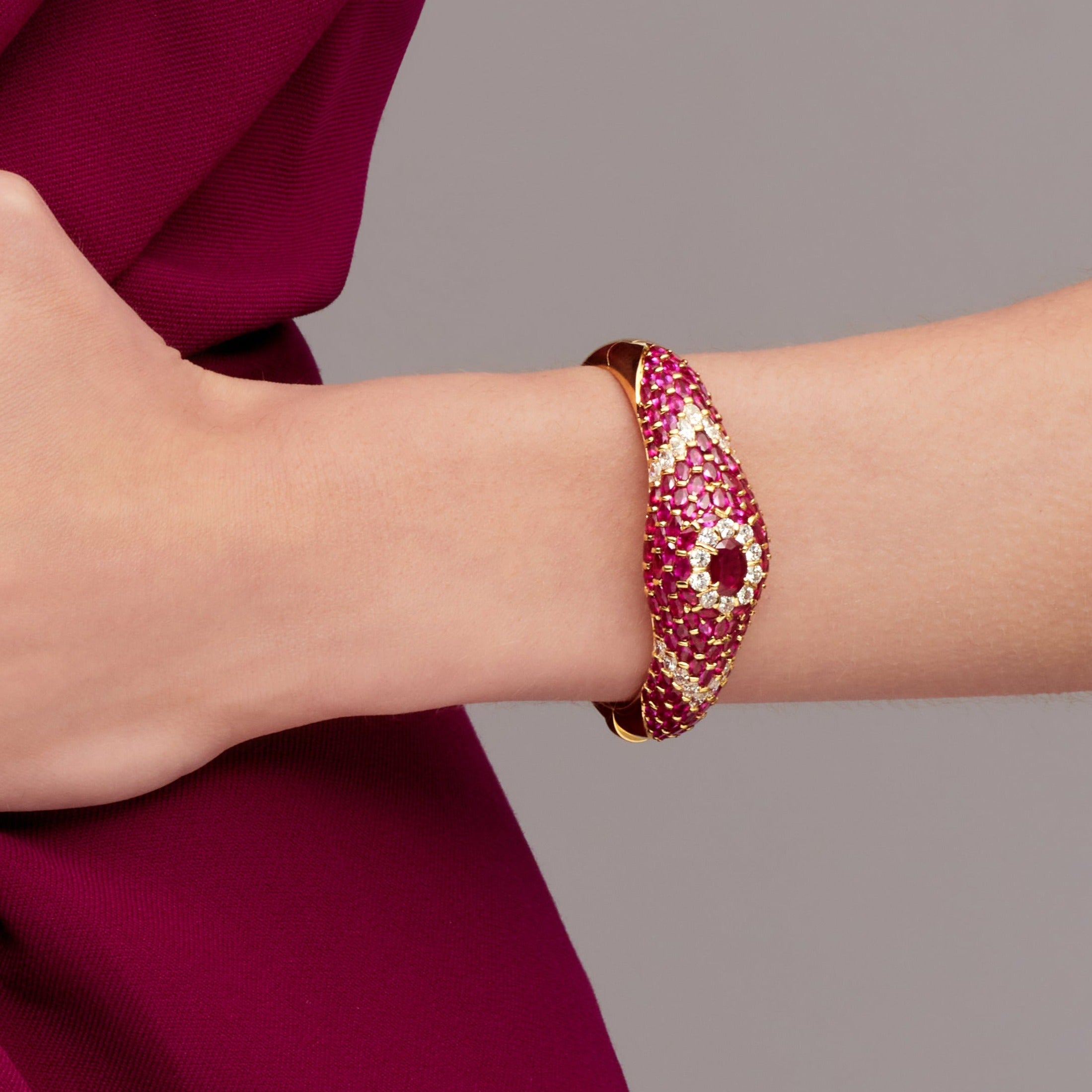 Oval Cut Ruby Cuff Bracelet with Diamond Accents in Yellow Gold