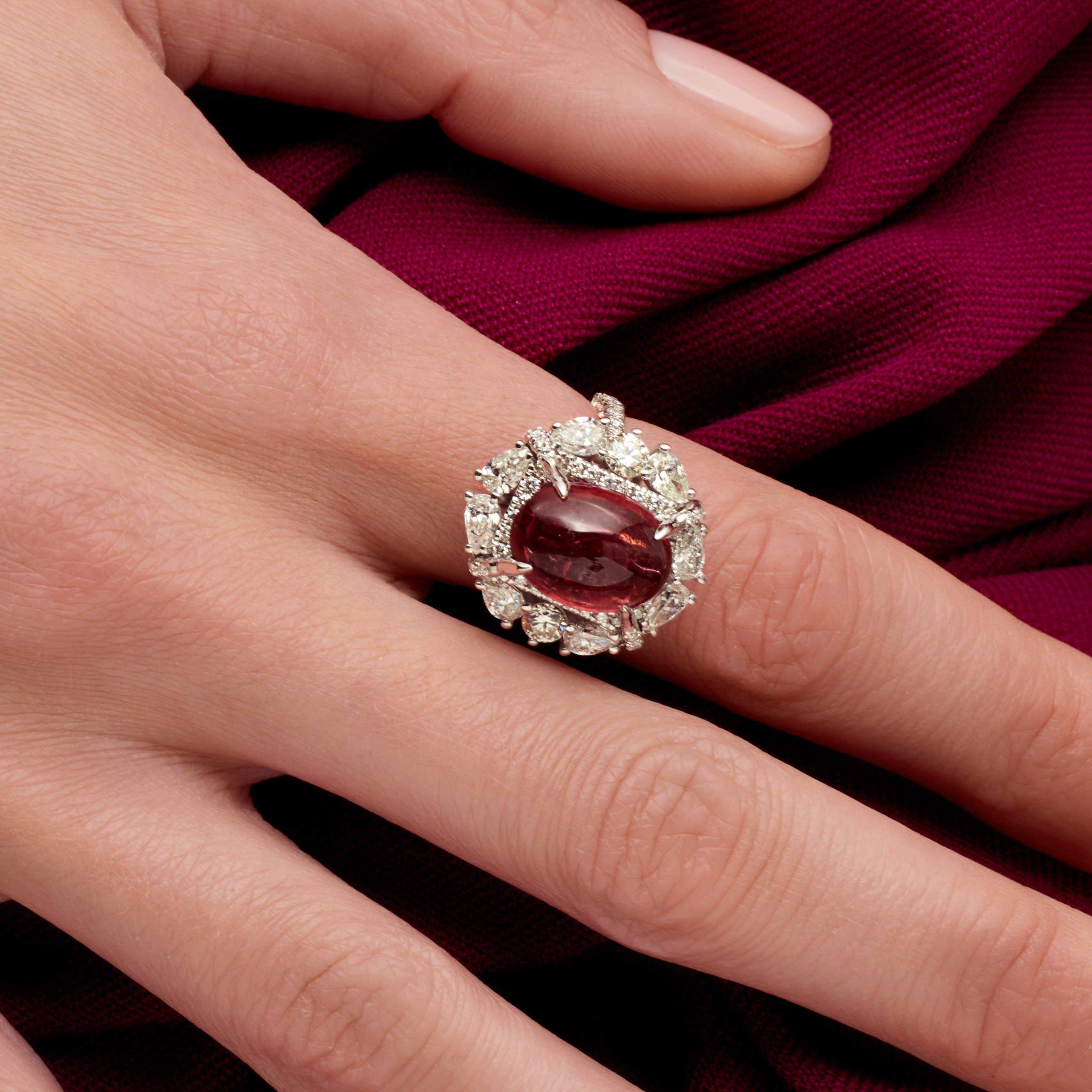 Oval Cut Ruby Cabochon Ring With A Diamond Halo In Platinum Ruthenium