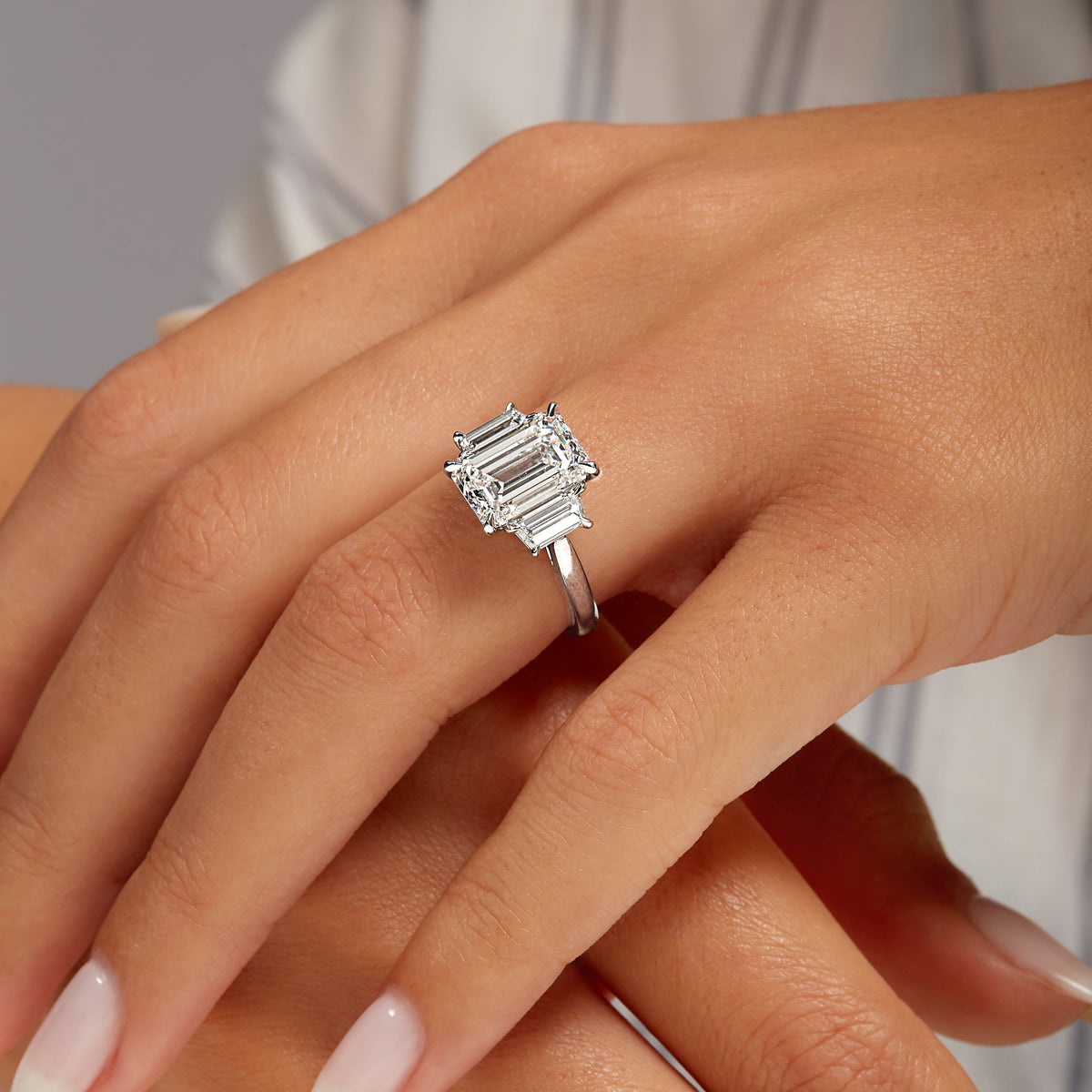 4.01ct Emerald Cut Diamond Three Stone Ring with Trapezoid Side Stones in Platinum Band, GIA Certified