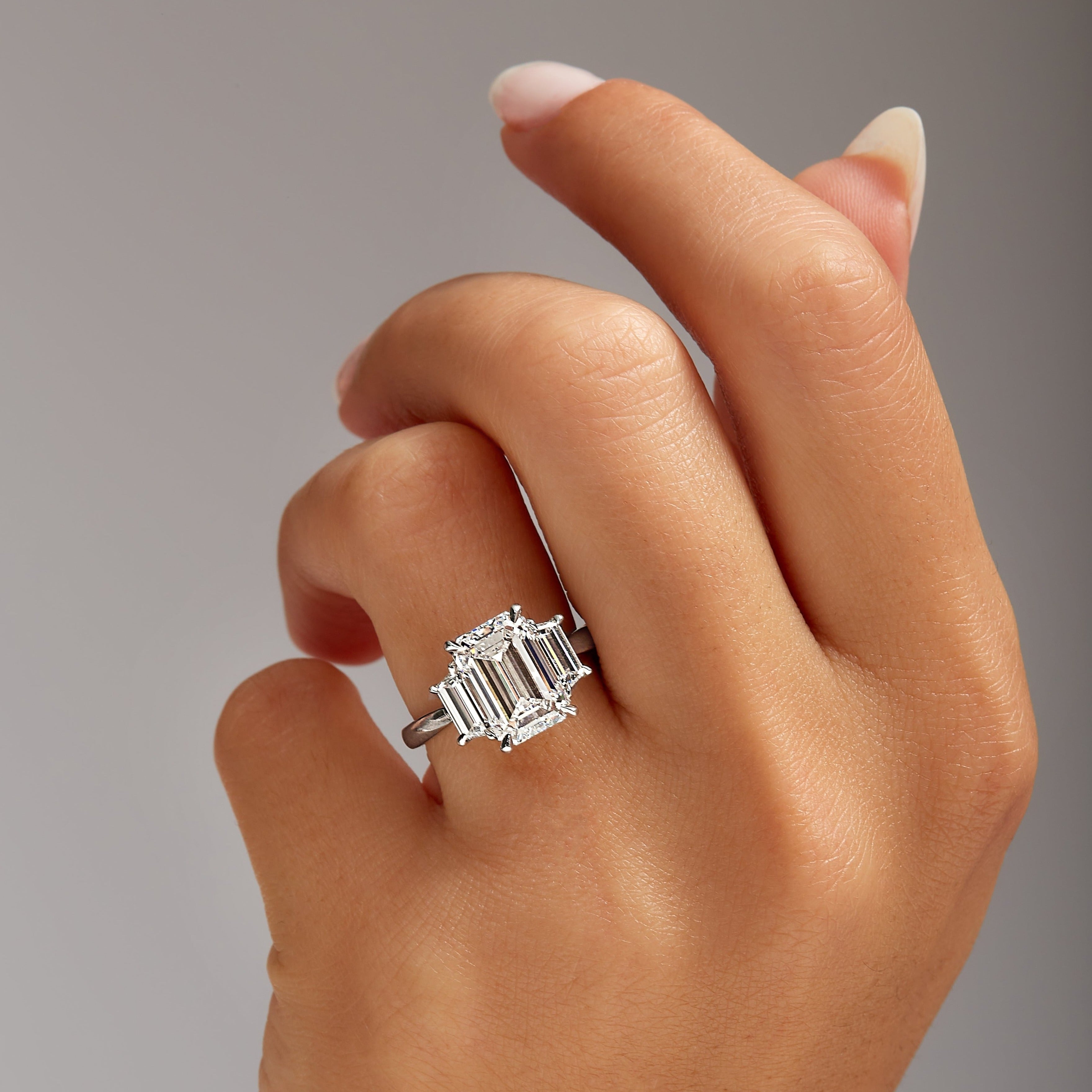 4.01ct Emerald Cut Diamond Three Stone Ring with Trapezoid Side Stones in Platinum Band, GIA Certified